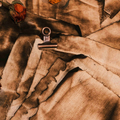 Vintage-style distressed and tattered fabric, suitable for art journaling, DIY collage, and wasteland-themed photo backdrops.