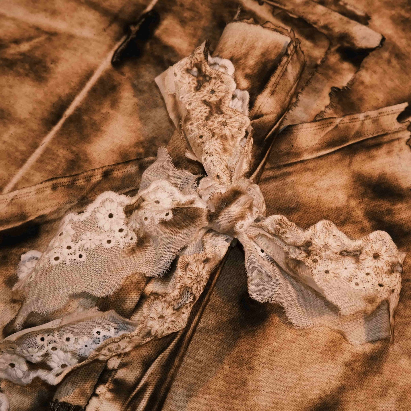 Vintage-style distressed and tattered fabric, suitable for art journaling, DIY collage, and wasteland-themed photo backdrops.